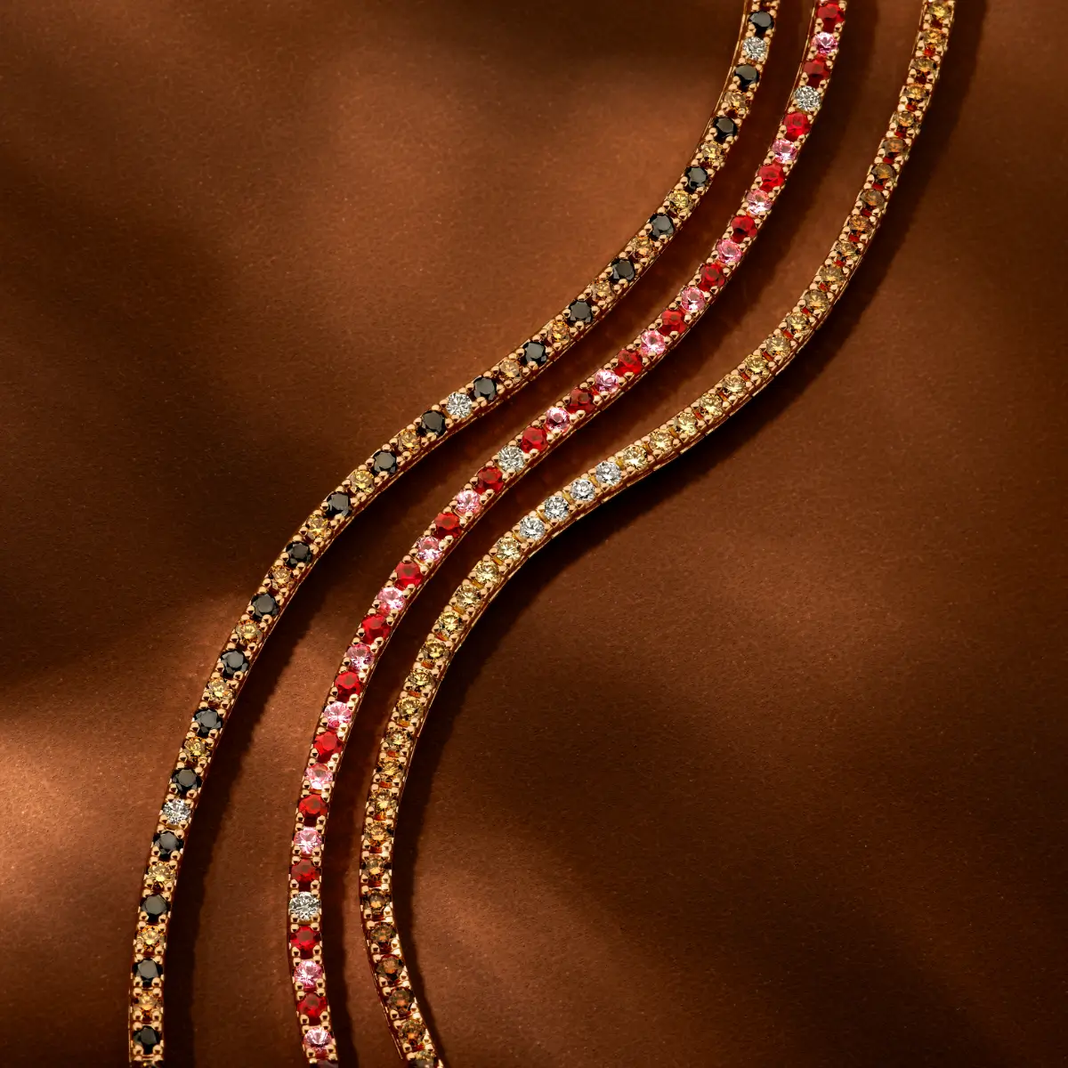 Gold Jagesar tennis bracelets fully set with rubies and clear diamonds as well as pink, brown and black diamonds